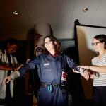 MIT AgeLab researchers Sophia Ashebir, left, and Taylor Brennan outfit Amy Dockser Marcus with the age-simulation suit.