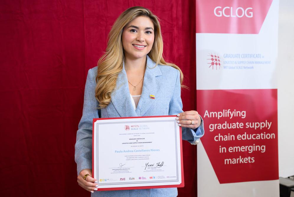 Woman with certificate in front of GCLOG banner
