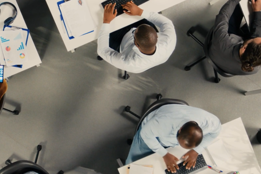 Top down image of people working at their desks